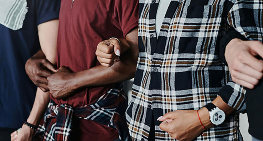 Men linked arm in arm